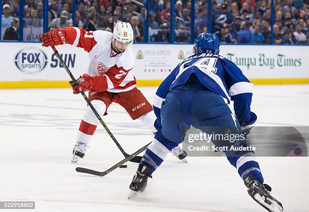 Ryan Callahan of the Tampa Bay Lightning skates against Tomas Tatar of the Detroit Red Wings during the second period of Game One of the Eastern...