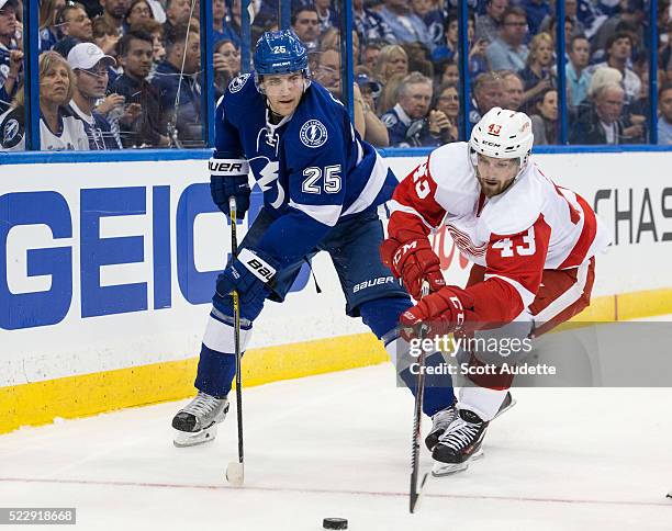 Matt Carle of the Tampa Bay Lightning skates against Darren Helm of the Detroit Red Wings during the second period of Game One of the Eastern...