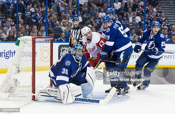 Goalie Ben Bishop and Valtteri Filppula of the Tampa Bay Lightning battles against Pavel Datsyuk of the Detroit Red Wings during the second period of...