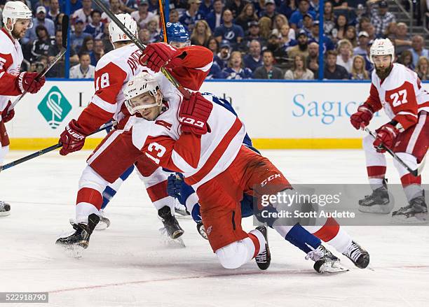 Pavel Datsyuk of the Detroit Red Wings falls against the Tampa Bay Lightning during Game One of the Eastern Conference Quarterfinals during the 2016...
