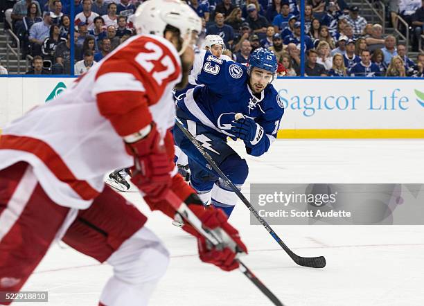 Cedric Paquette of the Tampa Bay Lightning skates against Kyle Quincey of the Detroit Red Wings during the third period of Game One of the Eastern...