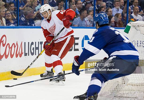 Brian Boyle of the Tampa Bay Lightning skates against Alexei Marchenko of the Detroit Red Wings during the third period of Game One of the Eastern...