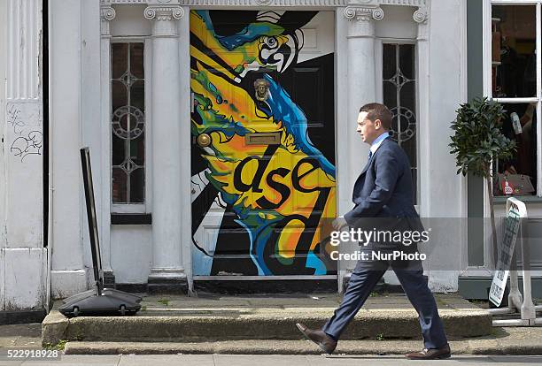 Man walks in front of a painted old door of a Georgian house on Harcourt Street, in Dublin city center. Dublin, Ireland, on Thursday, 21 April 2016.