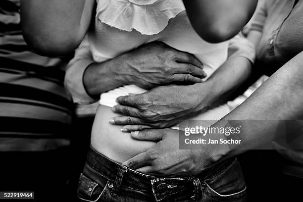 Colombian girl is seen held tightly by missionaries during the exorcism ritual performed at a house church on Janueray 28, 2013 in Bogota Colombia....