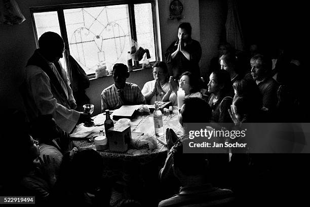 Colombian pastor celebrates a liturgy before performing the healing ritual at a house church on January 28, 2013 in Bogota, Colombia. Hundreds of...