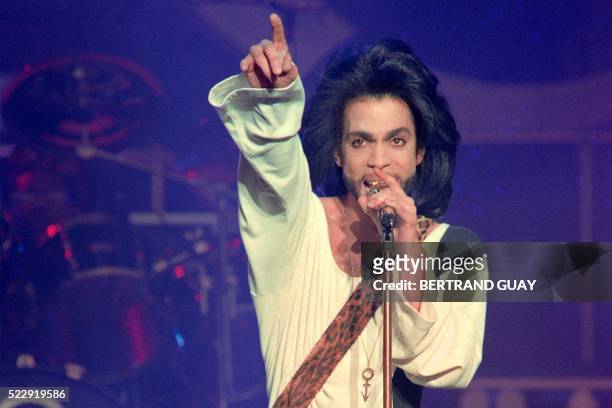 This photo taken on June 16, 1990 shows musician Prince performing on stage during his concert at the Parc des Princes stadium in Paris. Pop icon...