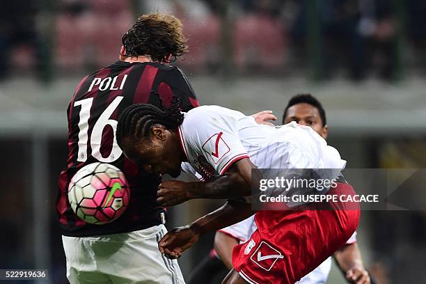 Milan's midfielder from Italy Andrea Poli fights for the ball with Carpi's forward from Nigeria Jerry Mbakogu during the Italian Serie A football...