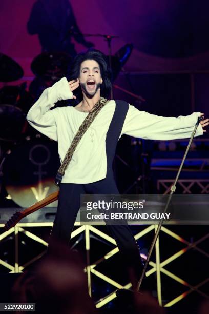 This photo taken on June 16, 1990 shows musician Prince performing on stage during his concert at the Parc des Princes stadium in Paris. Pop icon...