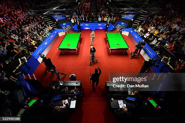 Alan McManus of Scotland makes his way into the arena for his second round match against Ali Carter of England on day six of the World Snooker...