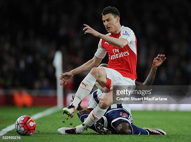 Laurent Koscielny of Arsenal challenged by Saido Berahino of WBA during the Barclays Premier League match between Arsenal and West Bromwich Albion at...