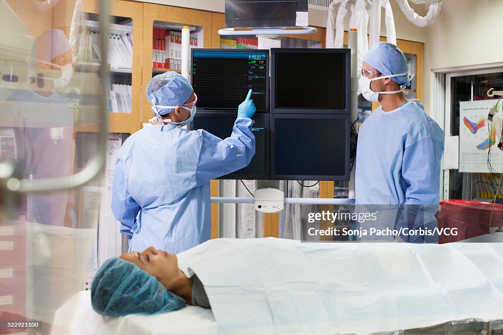 Surgeon Using Monitor Surgeon Pointing Towards Monitor During Surgery High-Res Stock Photo ...