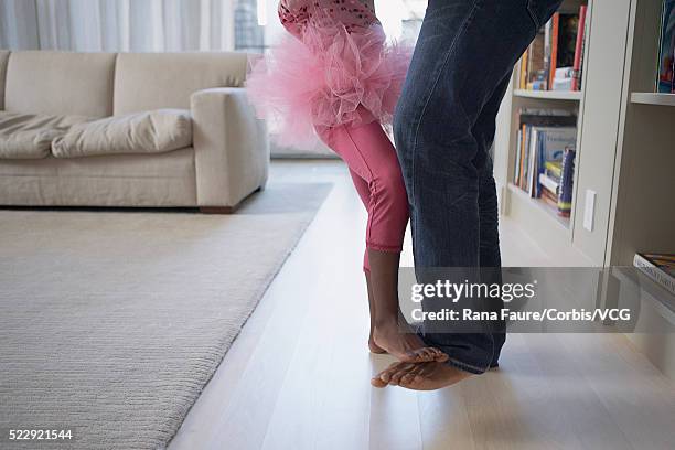 daughter standing on her father's feet - barefoot black men stock pictures, royalty-free photos & images