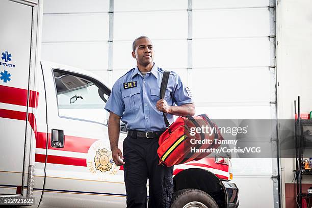 paramedic next to ambulance - paramedic stock pictures, royalty-free photos & images