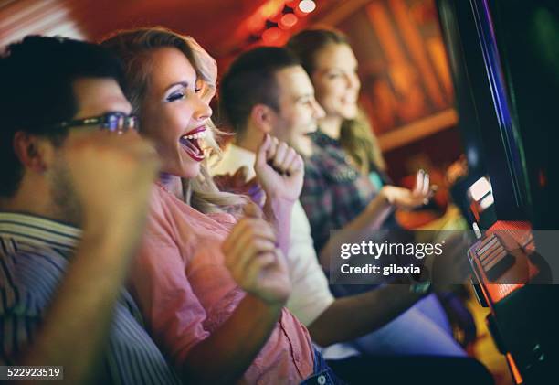 group of people playing slots in casino. - free bet slots no deposit【th733com】triple lucky slot machine stock pictures, royalty-free photos & images