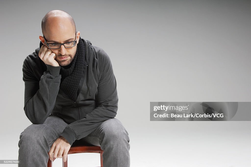 Disappointed man sitting on a chair