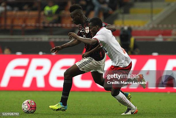 Mario Balotelli of AC Milan competes for the ball with Isaac Cofie of Carpi FC during the Serie A match between AC Milan and Carpi FC at Stadio...