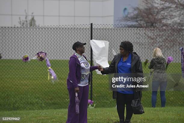 Teia Buroton, a Paisley Park volunteer, consoles a mourner outside Prince's home on April 21, 2016 in Chanhassen, Minnesota. Prince died earlier...