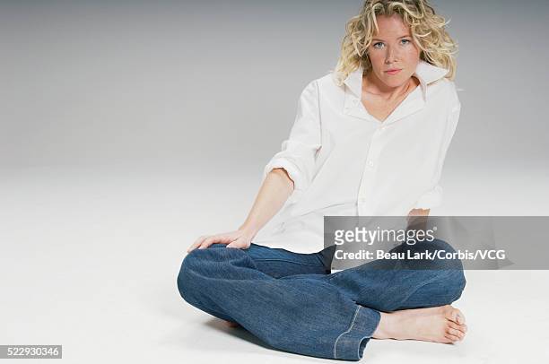serious young woman sitting cross-legged - fashion design minimalist edgy stock pictures, royalty-free photos & images
