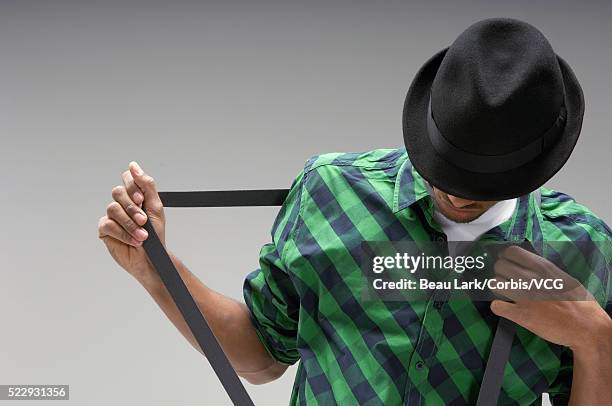 man pulling at suspenders - black baseball hat on white stock pictures, royalty-free photos & images