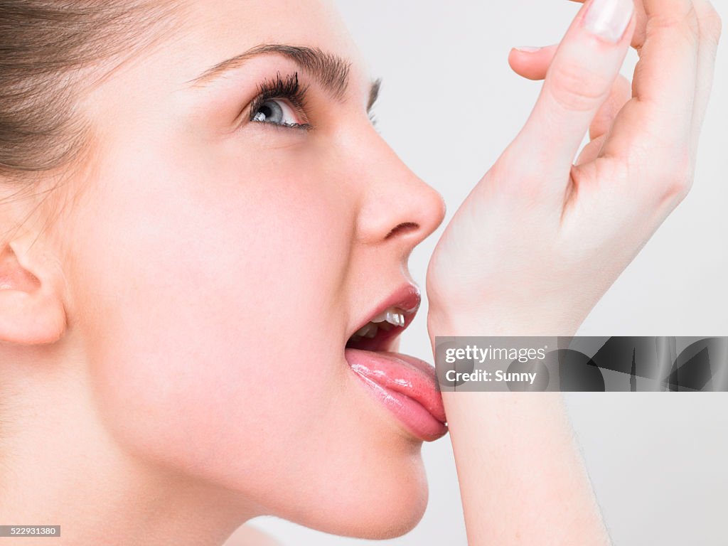 Woman Licking Her Wrist