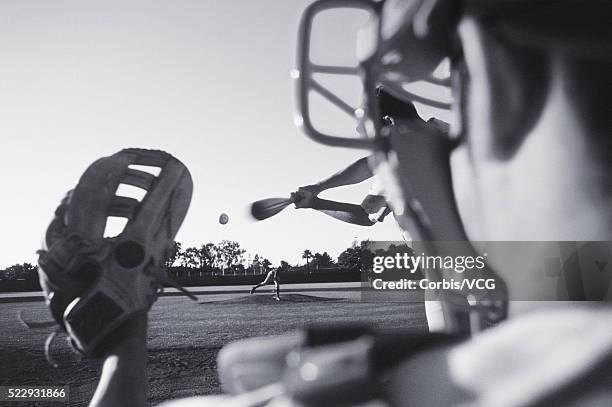 catcher's view of baseball batter swinging at ball - baseball pitcher catcher stock pictures, royalty-free photos & images