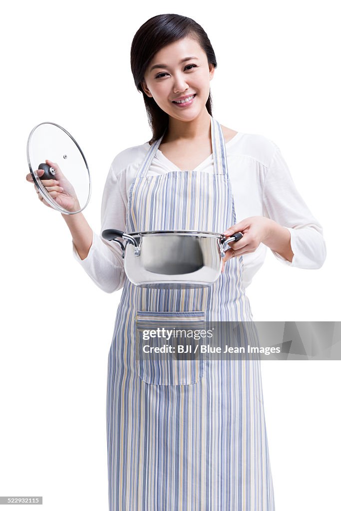 Happy housewife preparing meal