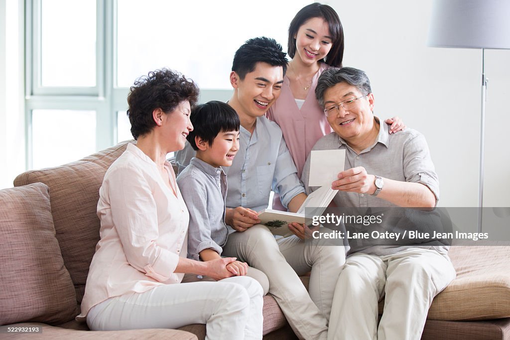 Happy family looking at photo album