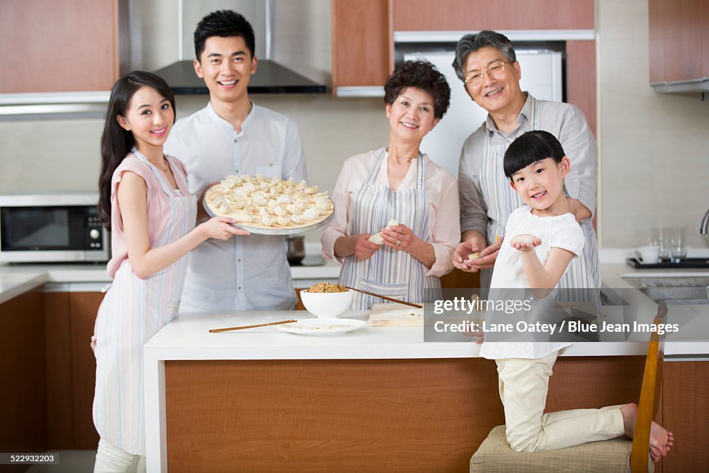 Happy family making dumplings
