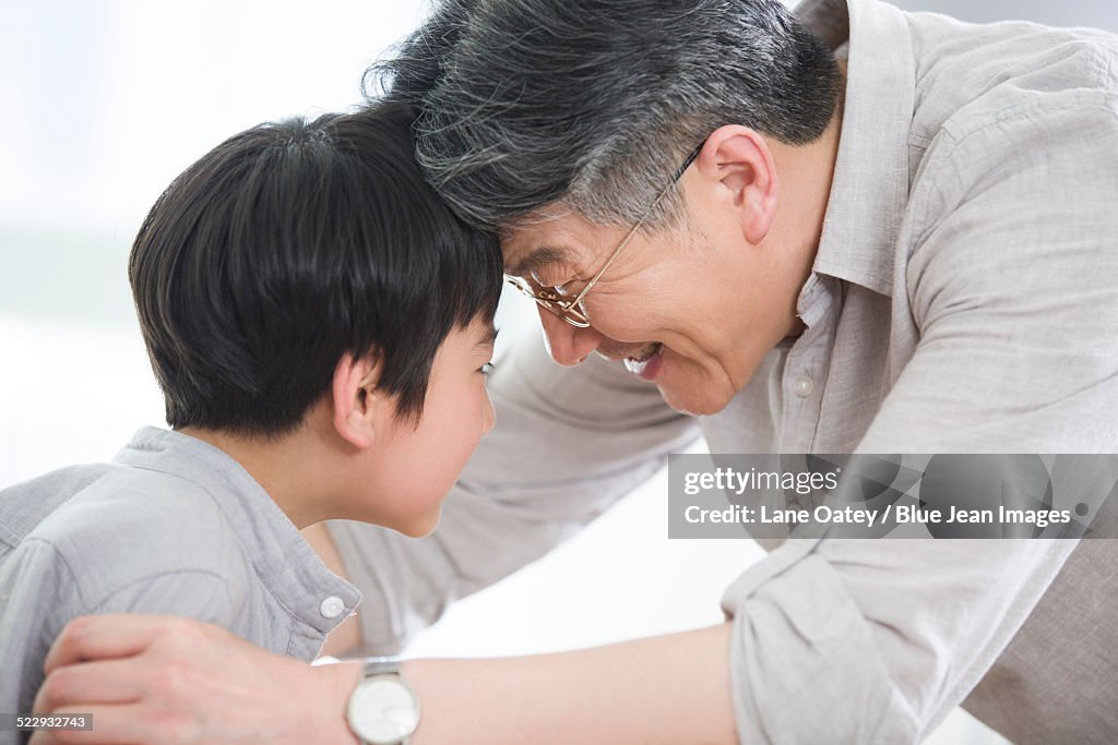 Happy grandfather and grandson playing games