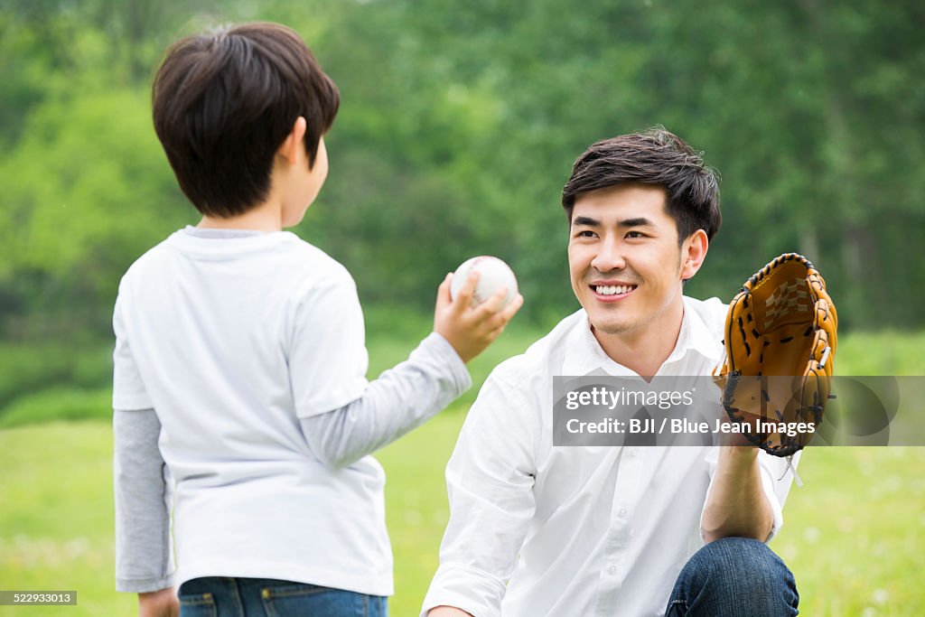 Father teaching son how to play baseball
