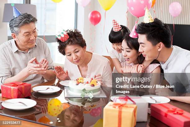 happy family celebrating birthday - light vivid children senior young focus foto e immagini stock