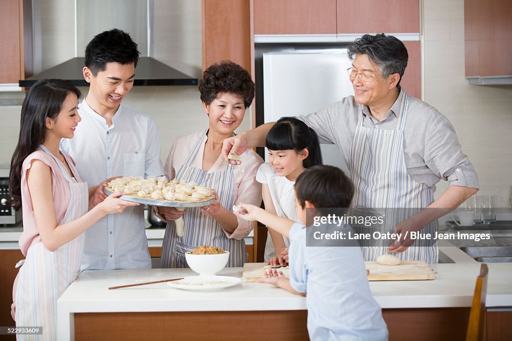 Happy family making dumplings