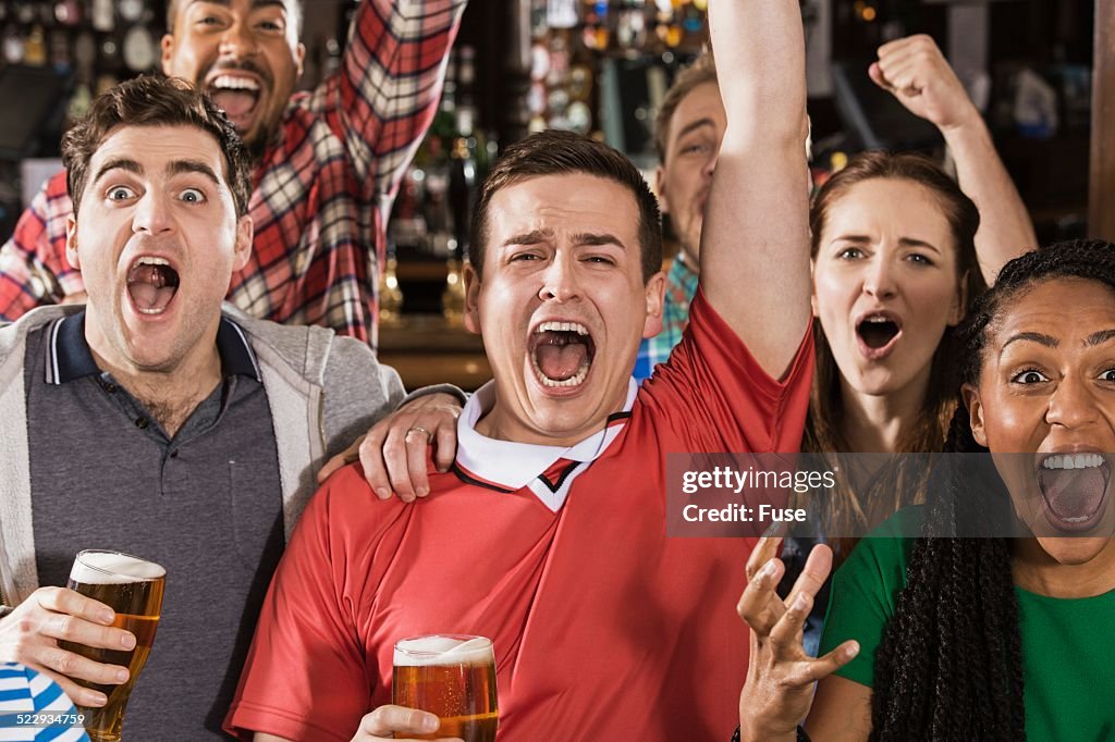 Soccer fans watching game in pub