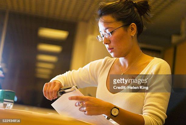 businesswoman doing paperwork - staples office stockfoto's en -beelden