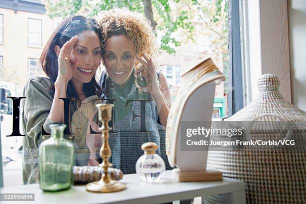 mid-adult women window shopping - choosing perfume stock pictures, royalty-free photos & images