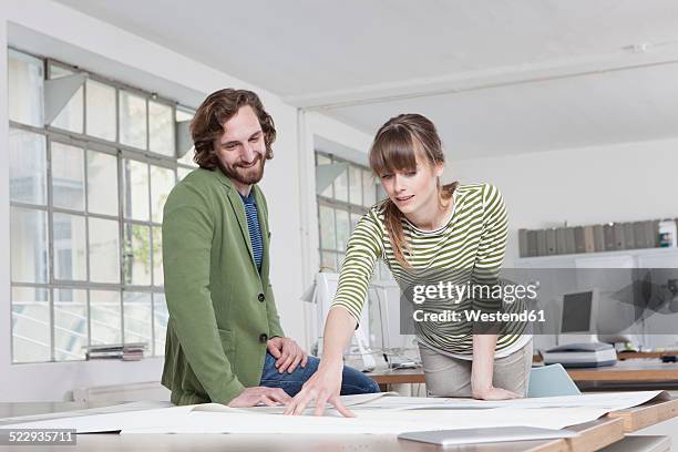 two colleagues looking at conception in a creative office - muenchen team presentation stock pictures, royalty-free photos & images