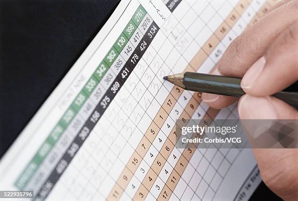 golfer filling in scorecard - scorecard stock pictures, royalty-free photos & images