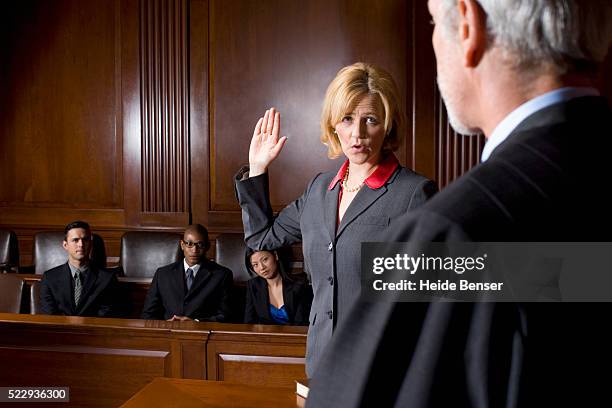 witness giving oath during trial - courtroom jurors judge stock pictures, royalty-free photos & images