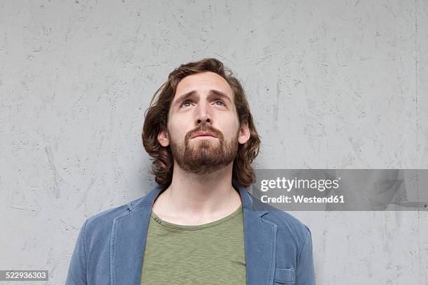 portrait of thoughtful young man looking up - man with gray hair stock pictures, royalty-free photos & images