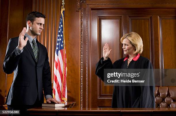 witness giving oath during trial - woman judge stock pictures, royalty-free photos & images