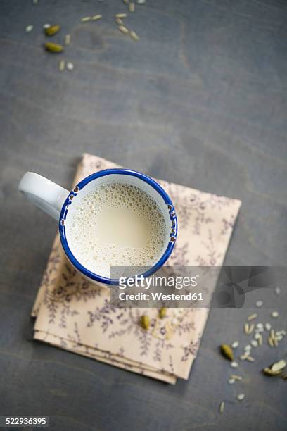 cup of soy rice milk with cardamom and cinnamon on napkin aund wood, elevated view - soy milk bildbanksfoton och bilder