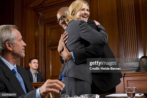 lawyer and defendant celebrating victory in trial - trial stock pictures, royalty-free photos & images