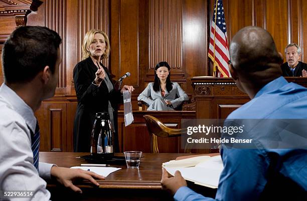 lawyer presenting evidence during trial - courtroom stock pictures, royalty-free photos & images