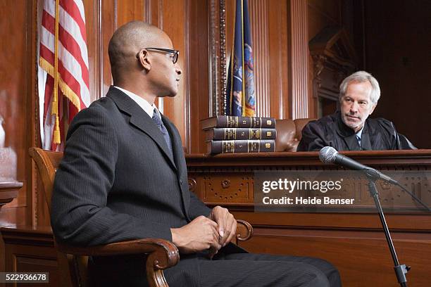 witness and judge talking during trial - courtroom stock pictures, royalty-free photos & images