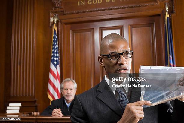 lawyer presenting evidence during trial - courtroom stock pictures, royalty-free photos & images