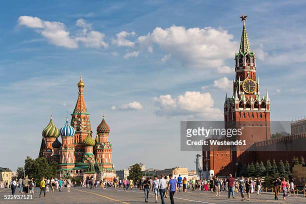 russia, moscow, saint basil's cathedral with kremlin wall and spasskaya tower - kremlin stock pictures, royalty-free photos & images