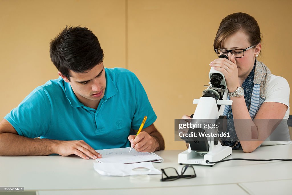 Vocational school students using optician device