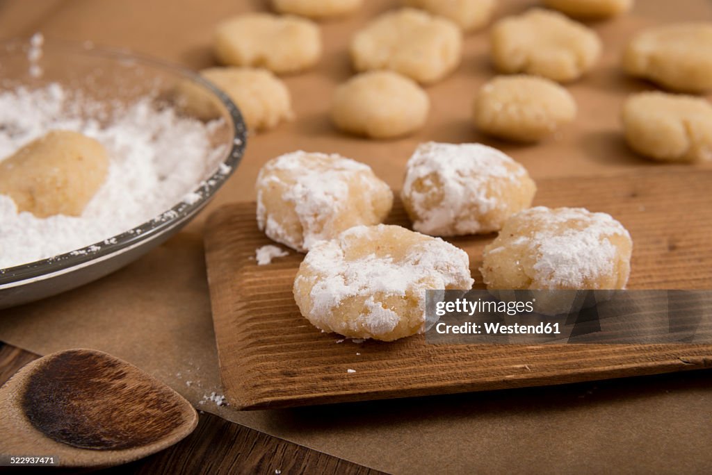 Raw homemade amarettini with icing sugar