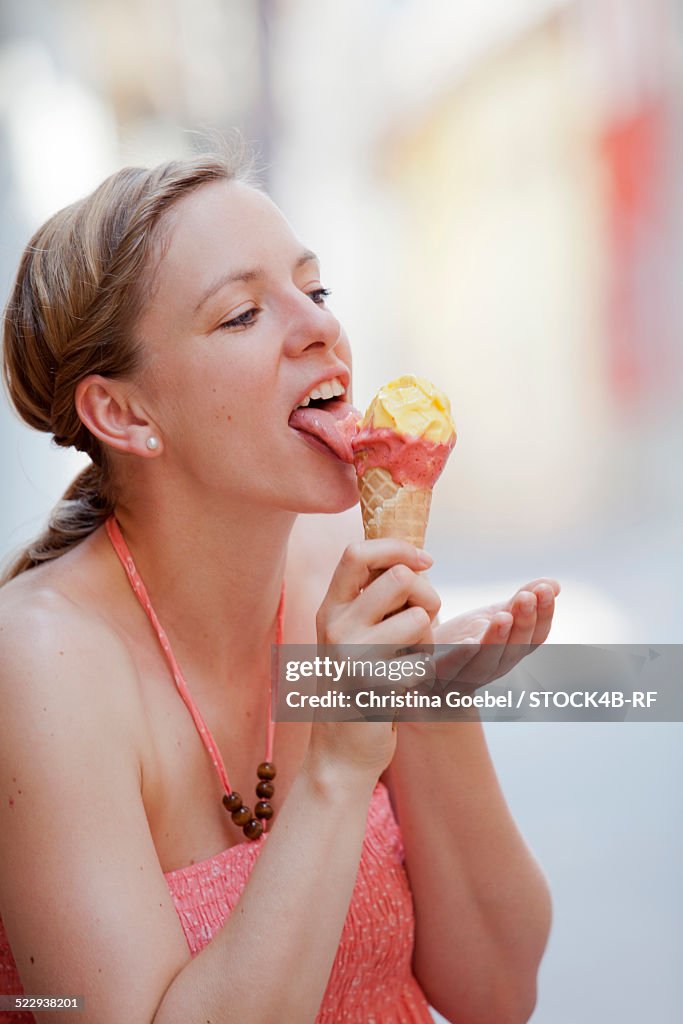 Blond woman eating ice cream cone