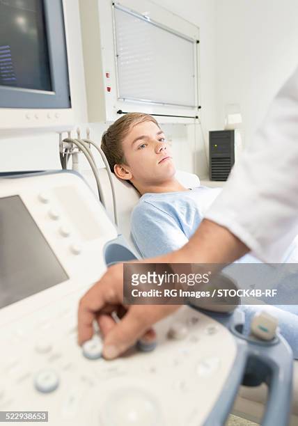 teenage boy having a sonography - ultra sonography stock pictures, royalty-free photos & images